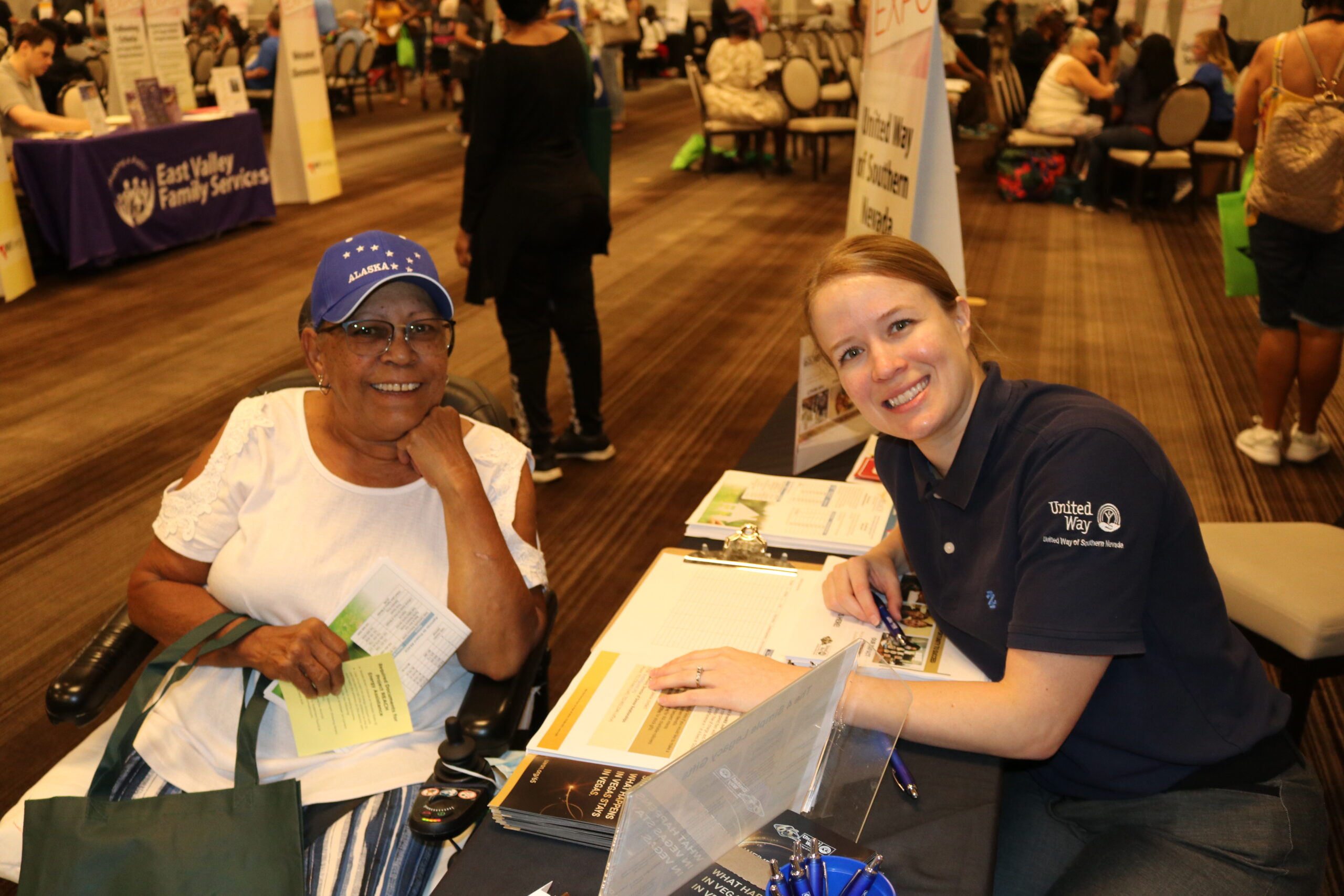 UWSN staff member assisting a senior at the Project REACH Senior Expo