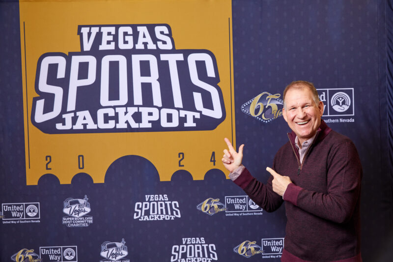 Greg Korte pointing at Golden Vegas Sports Jackpot Ticket.