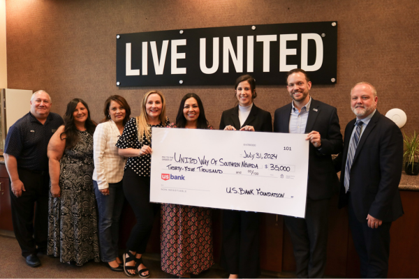 Group of people stand in front of a black and white sign that says Live United and hold a large U.S. Bank Foundation check for $35,000.