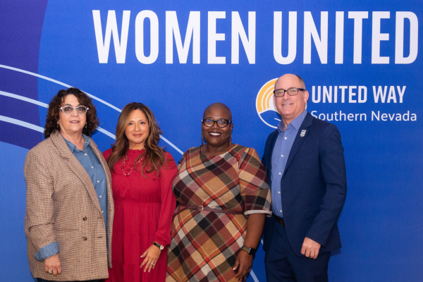 Four people standing in front of a blue background with Women United in white text across the top.