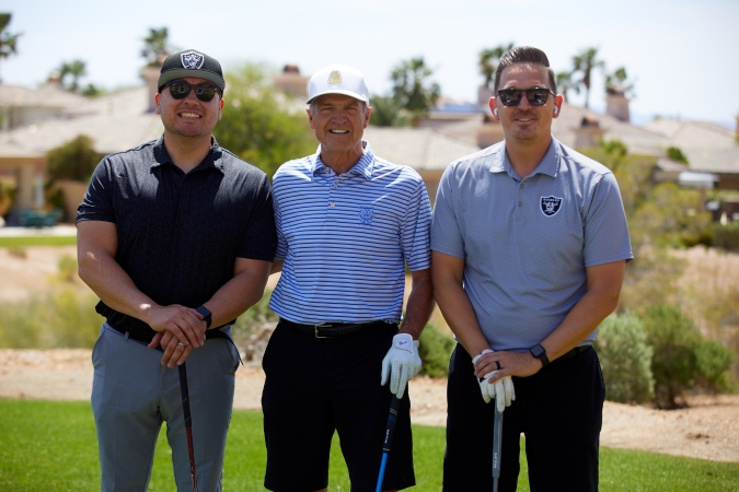 Three golfers on a course